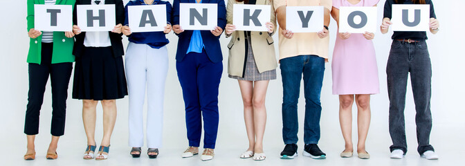 Studio shot of unrecognizable unidentified male and female officer staff in company office hold thank you alphabet cardboard paper sign on chest showing appreciation to customer on white background