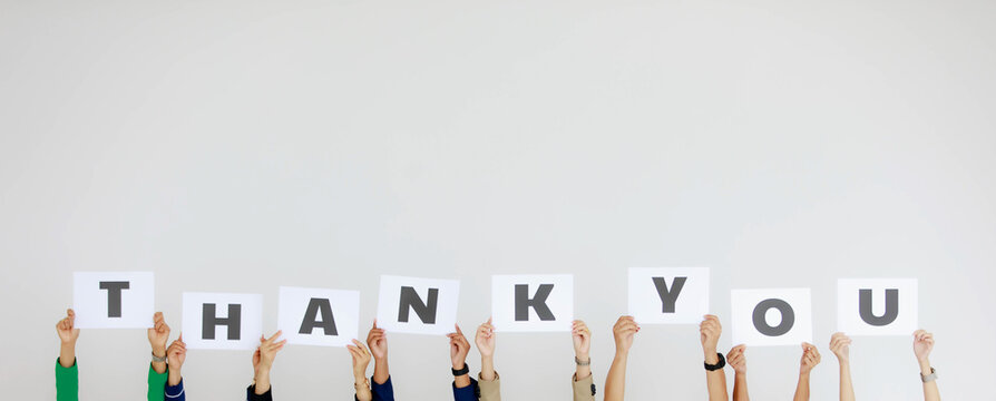 Studio Shot Of Unrecognizable Unidentified Group Of Staff Officer In Corporate Office Holding Thank You Alphabet Cardboard Paper Sign Over Head Showing Appreciation To Customer On White Background