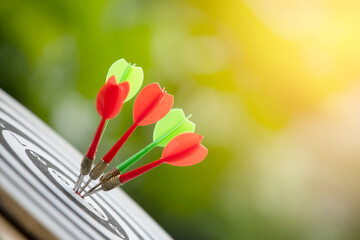 Close up bullseye or dart board has dart arrow hitting the center with nature backgrounds, business...