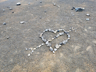 a heart with an arrow made out of stones