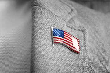 Metal badge with the flag of USA on a suit lapel