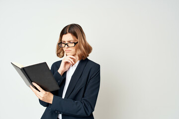 Business woman in suit with notepad in hands documents studio office