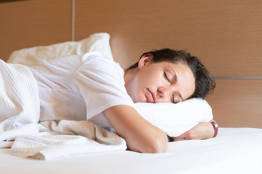 Close-up of an attractive young woman sleeping in bed at home