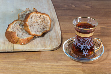 Cup of tea and cake on wooden background