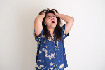 Young Asian women showing rage expression with her hands pulling hair