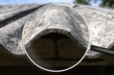 Old and very dangerous asbestos roof. Asbestos dust in the environment. Health problems. View...