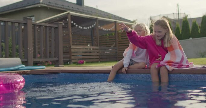 happy sisters wrapped in towel