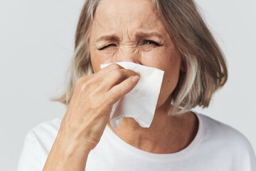elderly woman runny nose handkerchief cold
