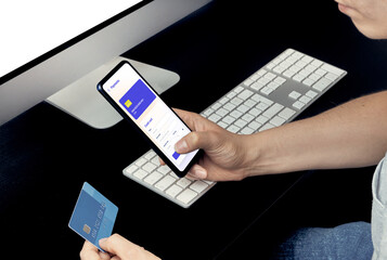 man using his credit card on his cell phone