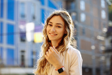 Fototapeta premium portrait of a woman in warm colors on a blurred background of the city