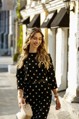 Fototapeta premium the girl smiles and walks through the city