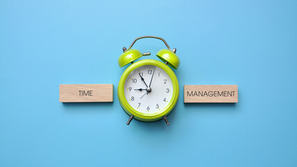 A green alarm clock and the inscription: "time management". Time Management Symbol