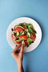 A person chooses the right food. Healthy snack: vegetable salad

