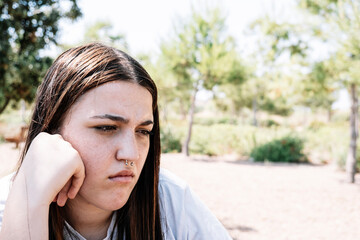 Teenager with pensive face staring into infinity.