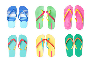 Set with different flip flops on white background, top view