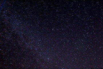 Night sky with andromeda as a blured bright spot in the center of the frame