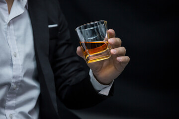 Closeup businessmen holding a glass of whiskey