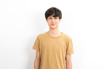 Handsome young man wearing casual t shirt looking confident at the camera with smile on white...