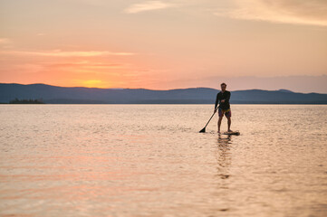 Sportsman paddling the standing board