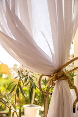 Curtain Of An Apartment Tied With A Rope Overlooking The Garden. Interior Decoration - obrazy, fototapety, plakaty