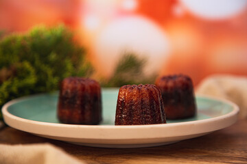 Caneles de Bordeaux on a plate at Cristmas Time