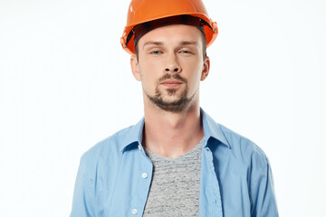 man in orange helmet blueprints builder light background