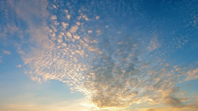 Golden sunrise or sunset cirrocumulus cloud on blue sky
