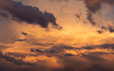 Naklejka na ściany i meble The sky during sunset. Orange sky and clouds.