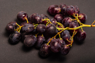 blue grapes in black background 