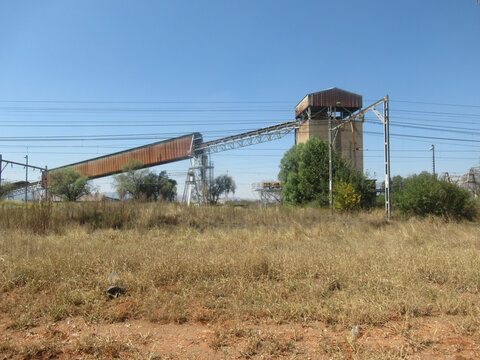 A defunct crusher plant from the days of yore standing stark and alone in the rural surroundings, silent and useless with the ghostly echoes of the crushing rocks of yesteryear.