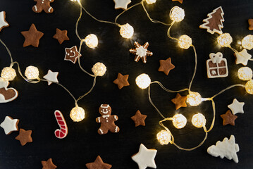 Glazed painted cookies: stars, gingerbread man, snowflakes, fir-tree and glowing Christmas garland
