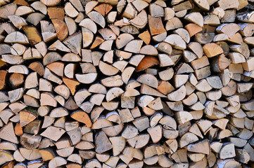 Preparation of firewood for winter. A woodpile made of birch wood. Copy space. Firewood background
