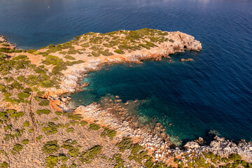 panoramic view of the sea and mountains and ships on turquoise water filmed from a drone