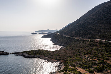 panoramic view of the sea and mountains and ships on turquoise water filmed from a drone