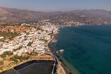 panoramic view of the sea and mountains and ships on turquoise water filmed from a drone