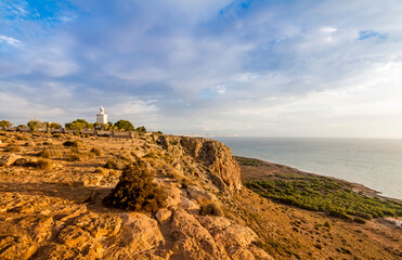 Obraz premium Santa Pola lighthouse. landscape of the Mediterranean coast in the city of Santa Pola. Coastal city located in the Valencian community, Alicante, Spain