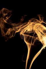 Gold smoke on black background.