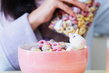 Unicorn clothes and color cereals for a funny breakfast at home