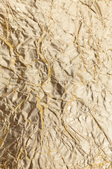 Crumpled gold paper background.