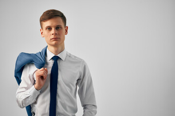 man in shirt with tie and jacket on his shoulders fashion work