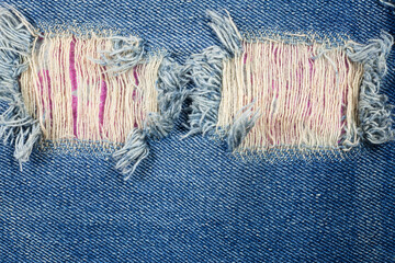 Detail torn old blue jeans background.