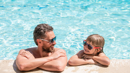 dad and child having fun at pool party. childhood and parenting. father and son