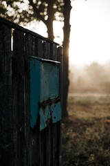 Old mailbox early in the morning on the fence