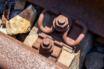 Closeup of old rusty railway bifurcated rails and rivets in the wild
