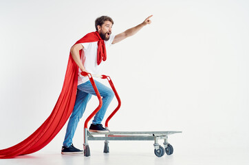 bearded man in a red cloak transport in a box light background