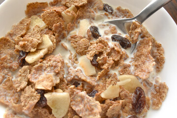 Fruit and fiber cereal with milk closeup in a bowl.  The concept of healthy breakfast, healthy food, dietary plan and weight loss program. 