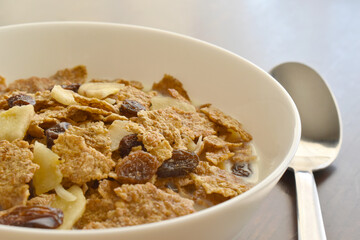 Fruit and fiber cereal with milk closeup in a bowl.  The concept of healthy breakfast, healthy food, dietary plan and weight loss program. 