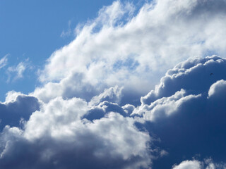 Dark and white clouds on a background of blue sky