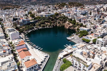 panoramic view of the Cretan city with white houses on the embankment near the sea filmed from a drone 