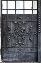 Element of a forged gate close-up. Antique church door.